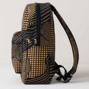 Studio side view of an African Kitenge print backpack with curved straps and utility pockets