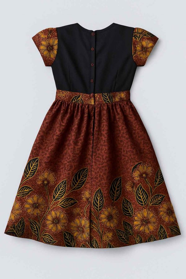 Back view of a girls’ kitenge flare dress with patterned short sleeves and button-down black bodice