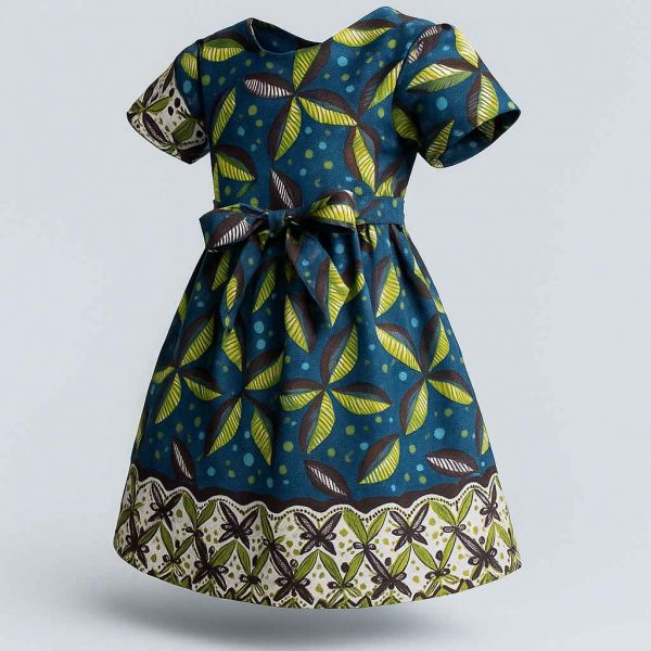 Angled view of handmade Kitenge girls’ dress with leaf print