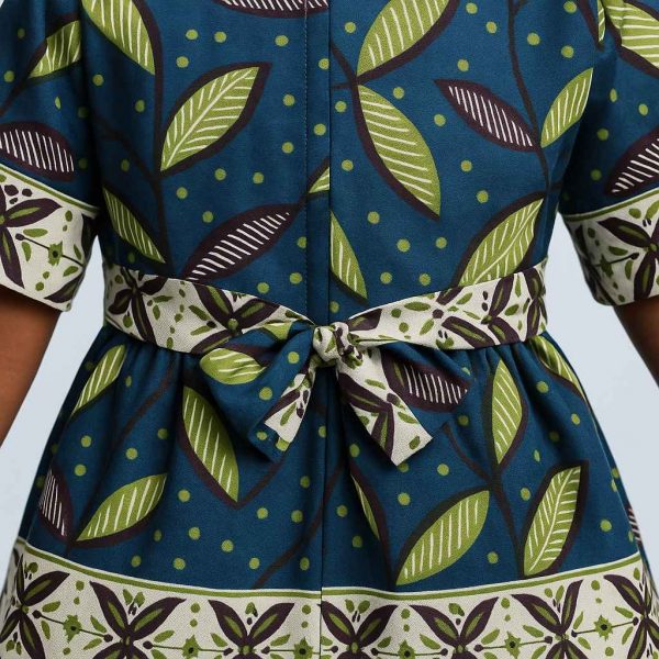 Close-up detail of handmade Kitenge girls’ dress with leaf print