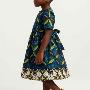 Side view of handmade Kitenge girls’ dress with leaf print