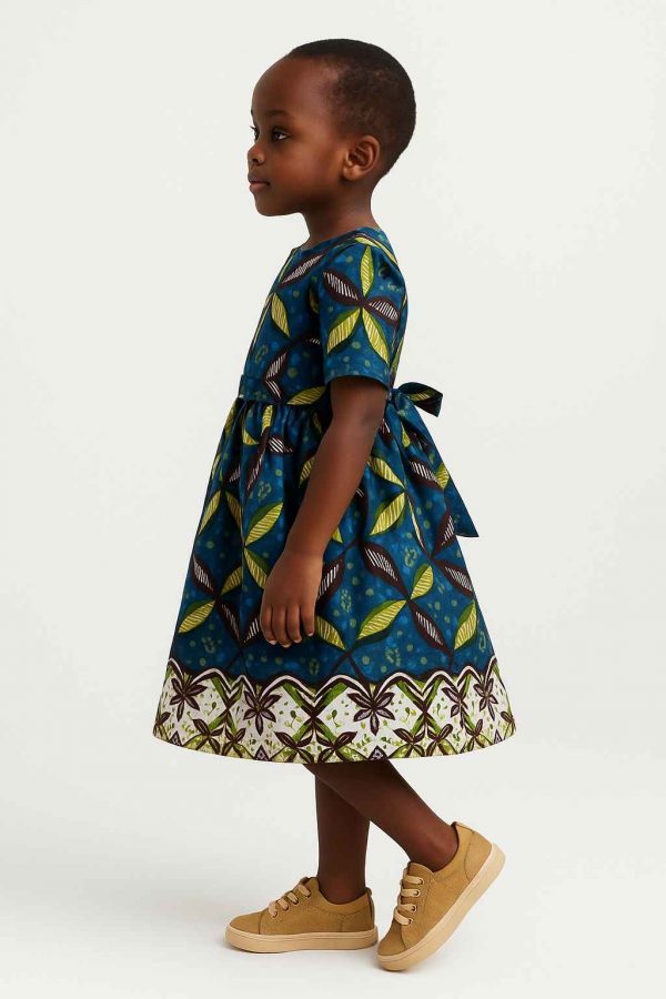Side view of handmade Kitenge girls’ dress with leaf print
