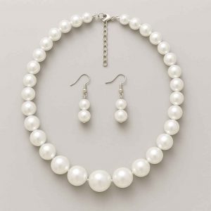 Studio back view of a pearl-style beaded necklace and earring set showing clasp and construction
