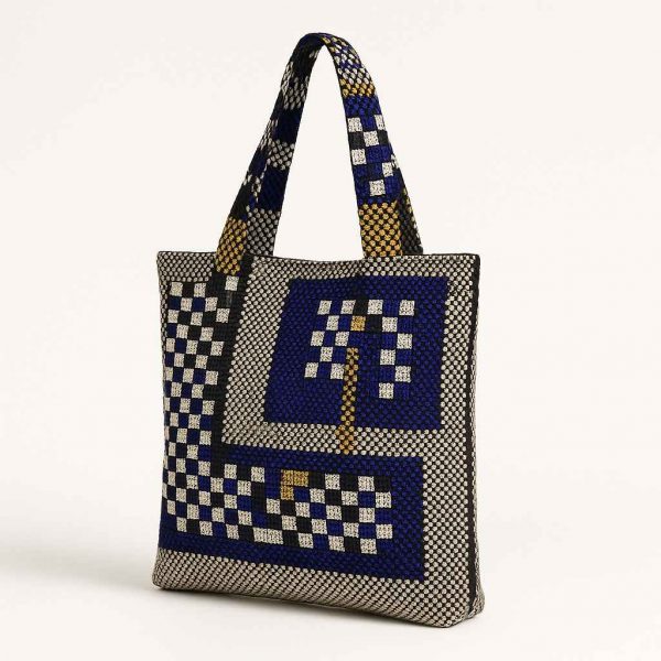 Angled view of a handmade woven checkerboard tote bag