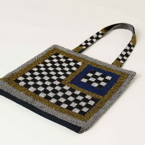 Bottom view of woven checkerboard tote bag showing thickness and base design