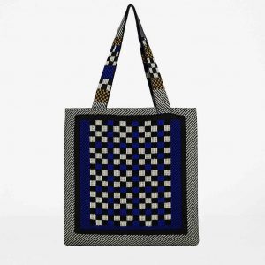 Back view of handmade checkerboard tote bag in black, white, blue, and mustard