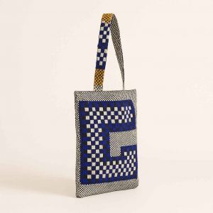Right side view of a handmade woven checkerboard tote bag