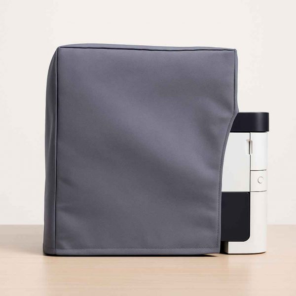 Side view of a neatly fitted fabric printer dust cover on a rectangular desktop printer