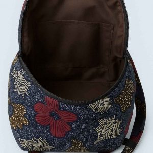 Tilted view of a handmade African Kitenge backpack, showcasing both the front and side panels with bold blue, white, and burgundy patterns.