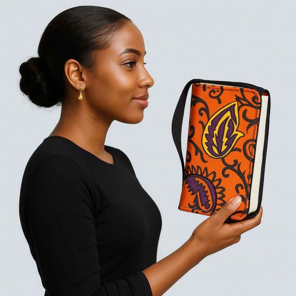Ugandan woman holding orange African Kitenge Bible cover side view