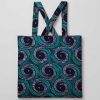 Front studio view of African kitenge tote bag in teal, purple, and blue swirl pattern