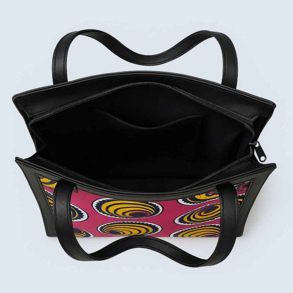 Top-down view of African Kitenge tote bag with pink yellow spiral print