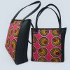 Ugandan woman holding African Kitenge tote pink yellow spiral bag