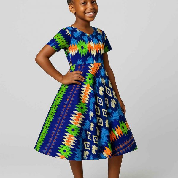 Young African girl smiling in a colorful kitenge flare dress with geometric and floral prints