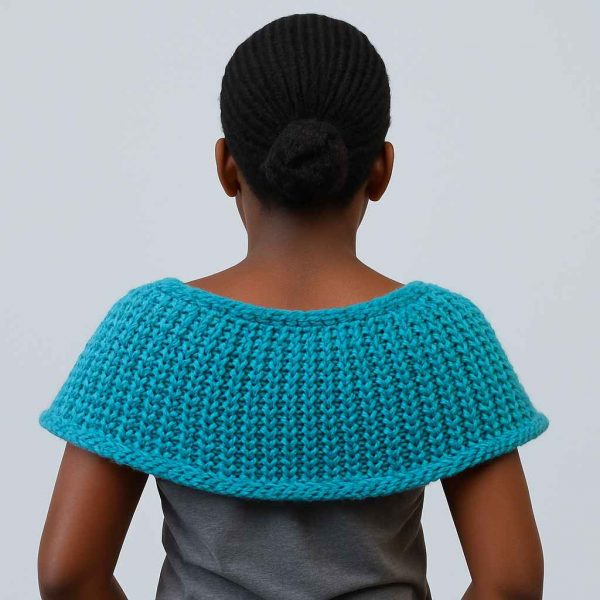 Studio image of a young African girl showing the back view of a handwoven capelet