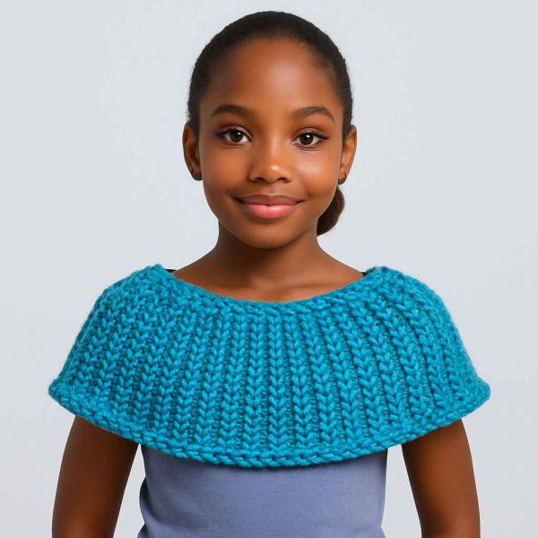 Young African girl confidently modeling handwoven capelet with hands on hips
