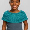 Elegant young African girl wearing handwoven capelet, front-facing with gentle smile