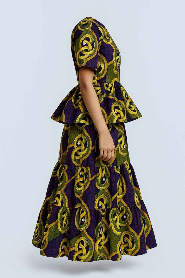 Side view of a girls’ tiered African kitenge peplum dress with layered skirt, short sleeves, and a defined waist