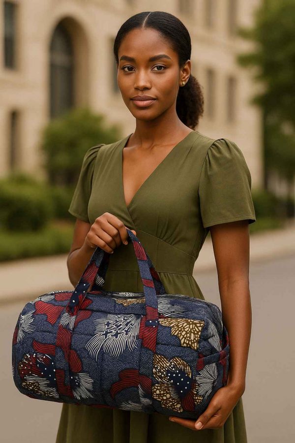 Beautiful African woman with stunning natural beauty carrying handmade kitenge duffle bag