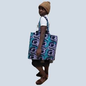 Side view showing the depth and strap construction of the African print bag