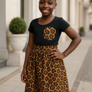 Smiling African girl in modest leopard-print skirt and black top