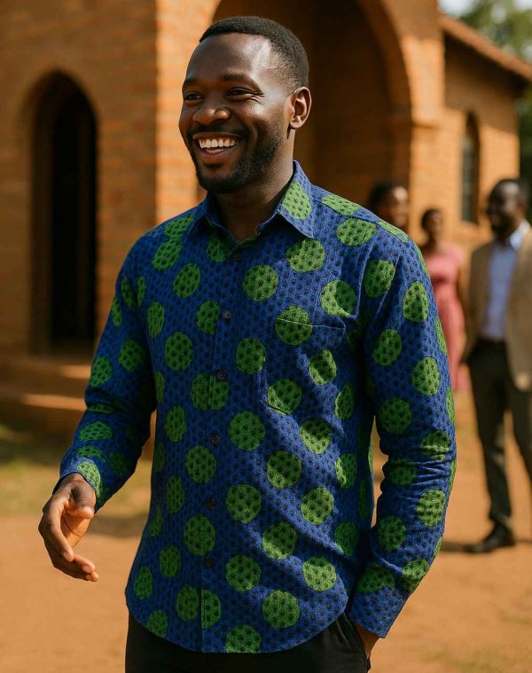 Ugandan man wearing men’s long sleeve blue and green Kitenge shirt outside church after Sunday service
