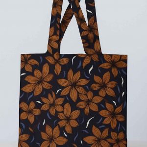 Front studio view of a handmade African print tote bag featuring orange floral design on dark background