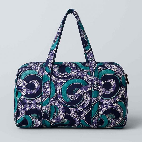 Back studio view of an African print duffle travel bag with visible stitching
