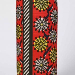 Front-facing studio image of an African print bolster cushion with red, yellow, and black patterned fabric