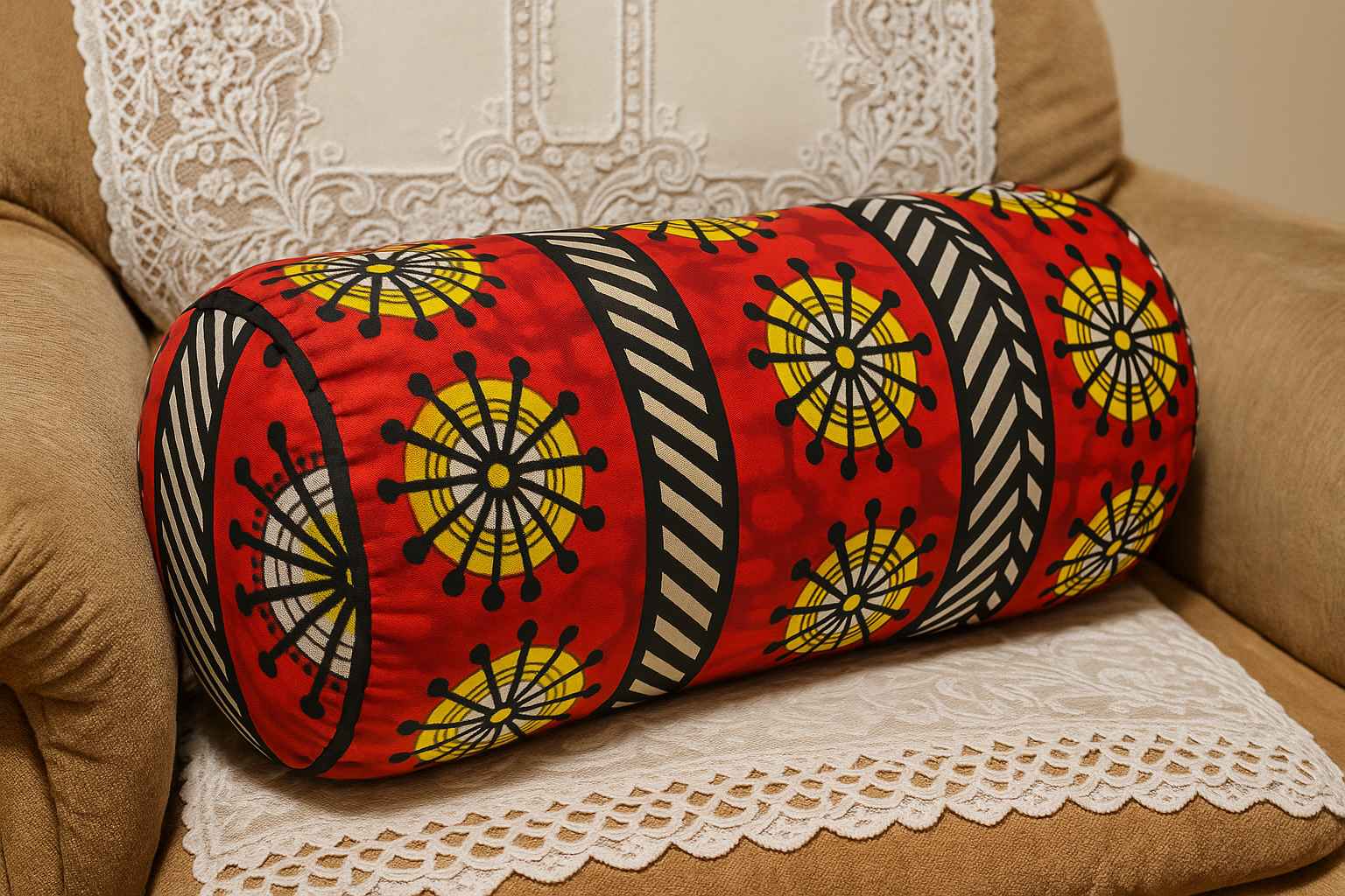 African print bolster cushion displayed on an armchair