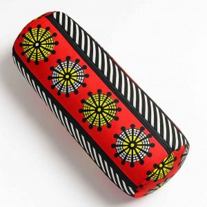 Overhead studio image of a handmade African print bolster cushion showcasing rounded top and symmetrical print