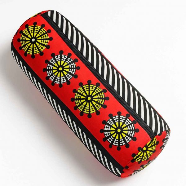 Overhead studio image of a handmade African print bolster cushion showcasing rounded top and symmetrical print