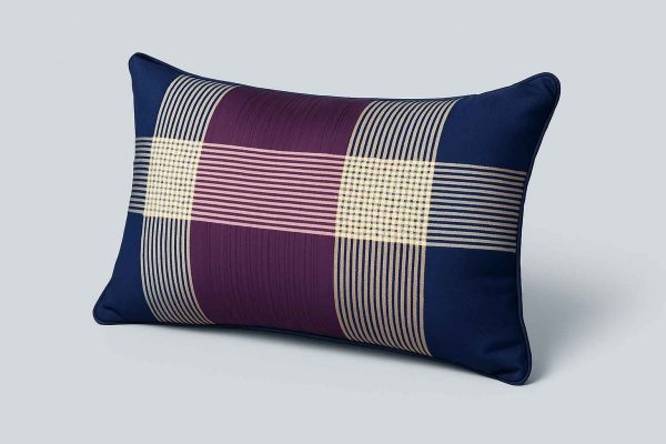 Angled view of a decorative striped pillow showcasing its texture and pattern