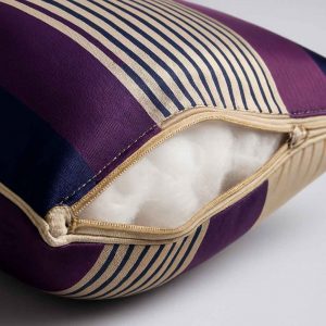 Close-up view of a striped throw pillow highlighting its fabric texture and stitching