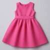Top-down view of handmade elegant girls’ dress