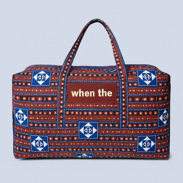 Handmade African Kitenge travel holdall shown from the front with traditional blue, red, and white pattern