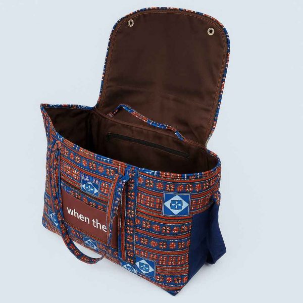 Handmade African Kitenge travel holdall with blue, red, and white pattern shown open to display interior compartments