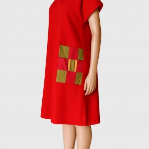 Right side view of a red knee-length handmade free dress with kitenge patch pocket