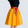 Golden flare skirt with colorful Kitenge waist tie side view