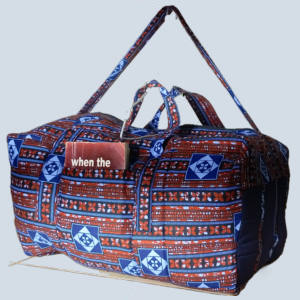 GraceTrail Kitenge Travel Holdall front view in blue, brick-red, and white African print handmade in Uganda