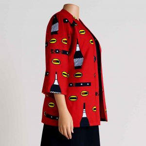 Side view of a red medium-sleeved African kitenge jacket styled with a dark skirt, displayed on a mannequin.