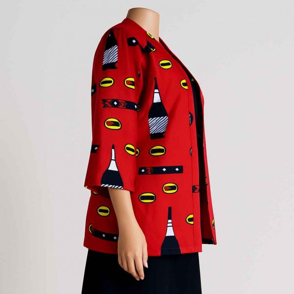 Side view of a red medium-sleeved African kitenge jacket styled with a dark skirt, displayed on a mannequin.