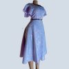 Side view of lavender modest midi dress with optional slim belt, flutter sleeves, and elegant flow.