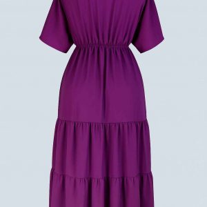 Back view of a royal purple tiered midi dress displayed on a mannequin in a studio setting