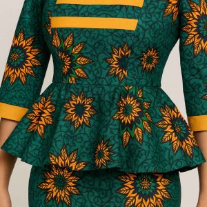 Close-up of the bodice and peplum waist of a women’s African dress with yellow trim and intricate pattern detail