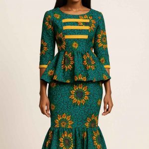 Studio portrait of a stunning African woman wearing a green, gold, and orange peplum dress with modest fit and mermaid silhouette
