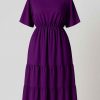 Royal purple tiered midi dress displayed on a mannequin against a clean studio backdrop