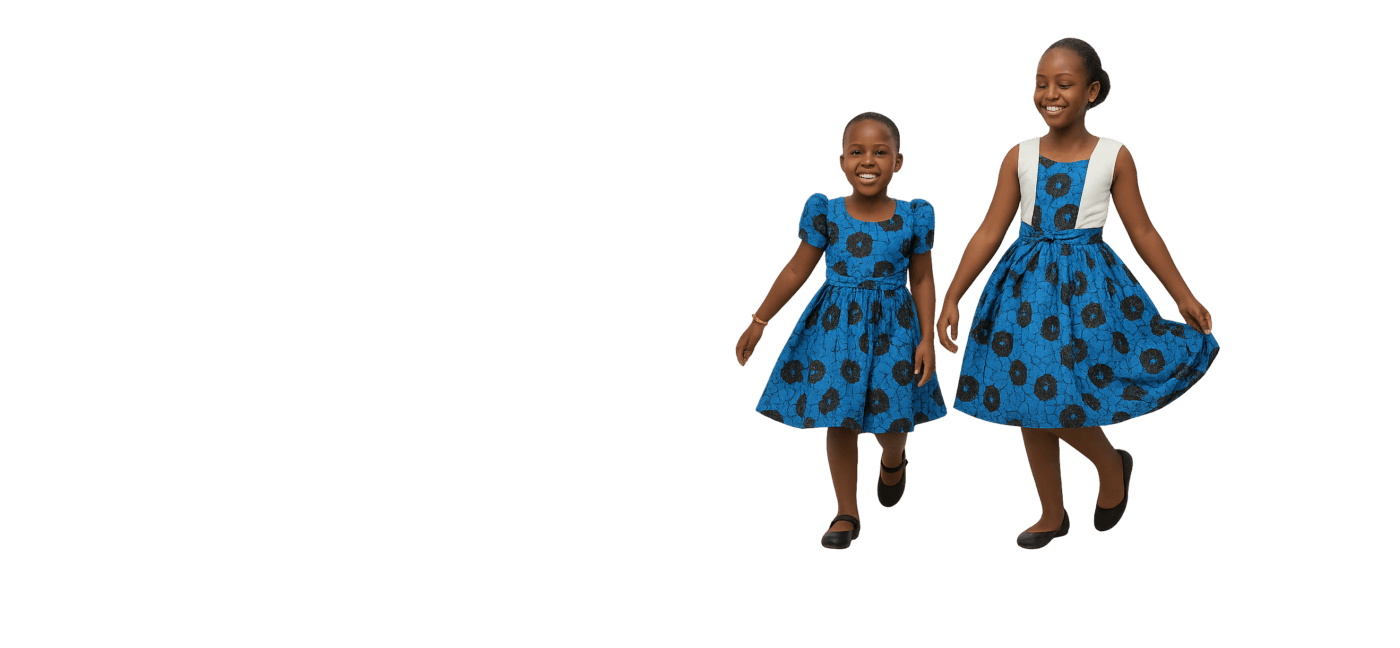 Two young African girls smiling in elegant blue patterned dresses, walking and posing gracefully to showcase Jackie Tailor’s professional children's wear