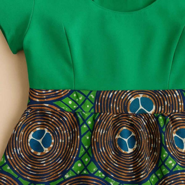 Close-up detail of swirl-pattern African Kitenge modest flare dress