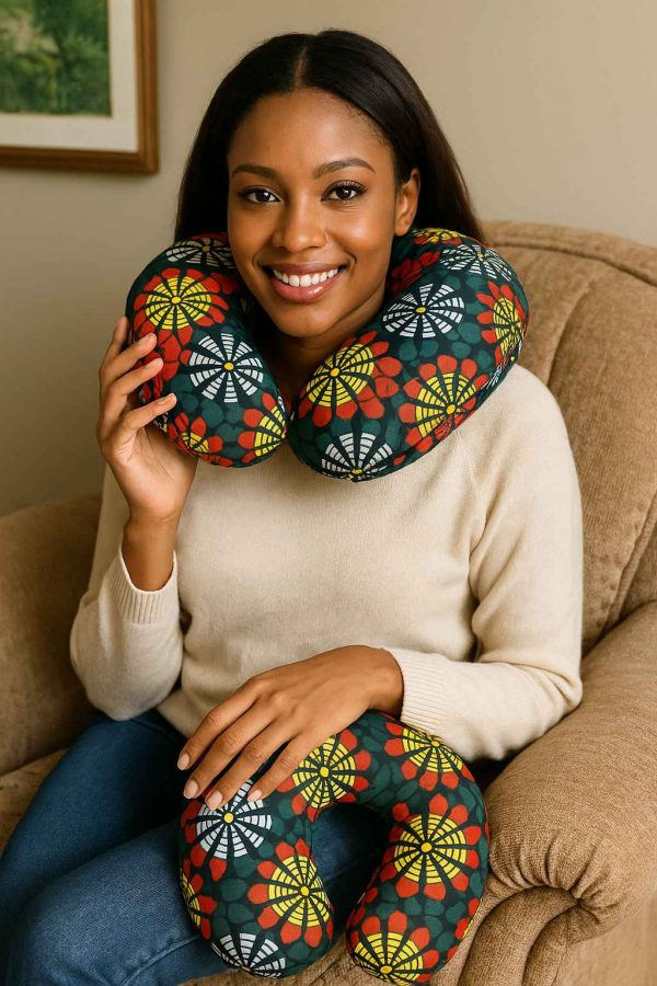 A young African woman seated with a U-shaped neck pillow in African print, showcasing comfort and support